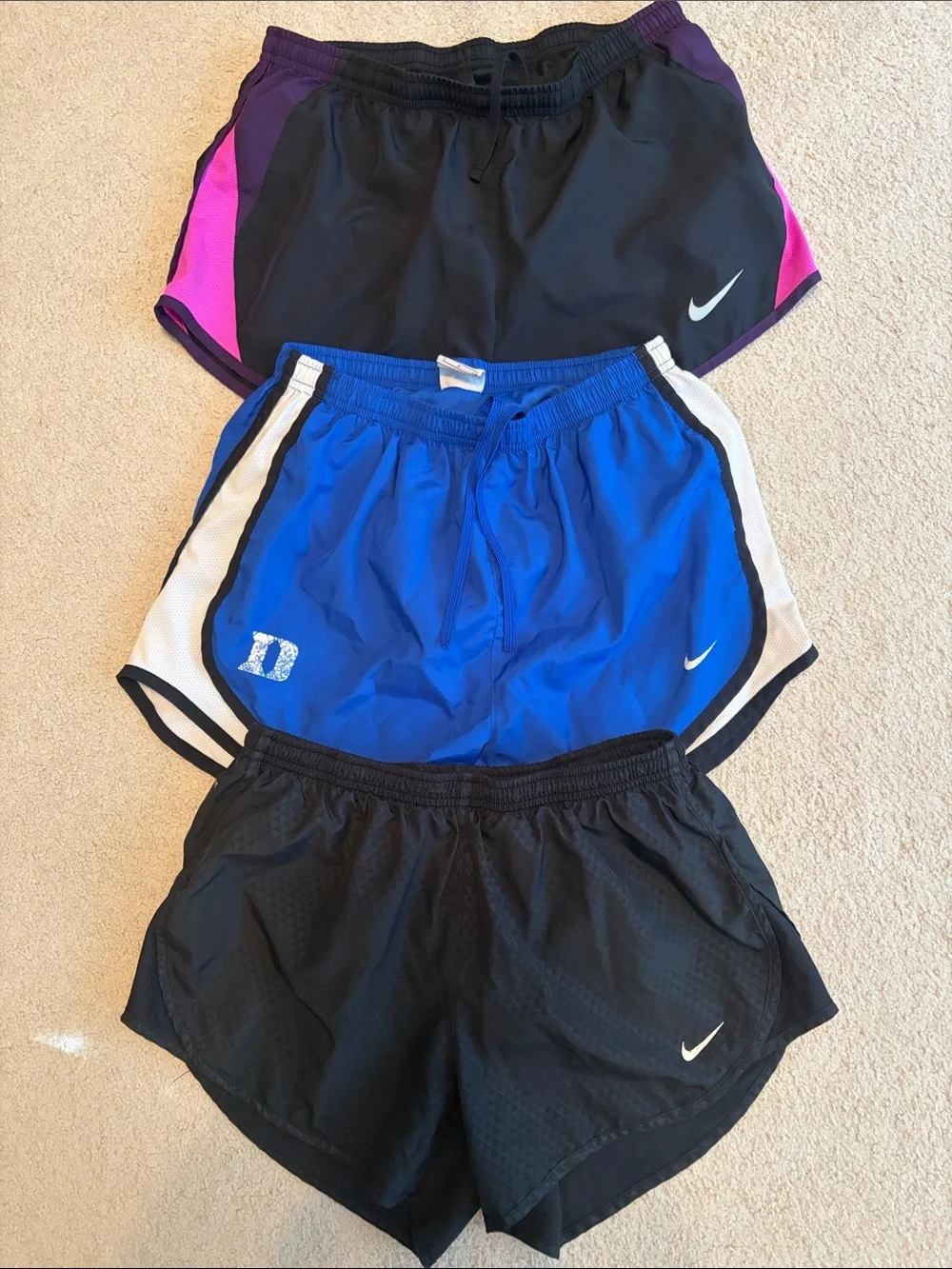 Nike Shorts Trio - Black pattern, Duke Blue, & black with purple & pink accents.
